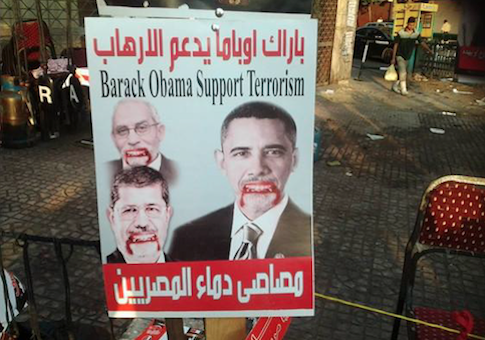 Pro-Army rally sign at Tahrir Square shows Obama, Egyptian President Morsi, and Muslim Brotherhood Supreme Guid Mohamed Badie as "bloodsuckers of the Egyptians" / Facebook