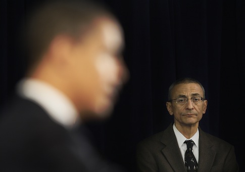 John Podesta listens as Obama answers questions at a news conference / AP
