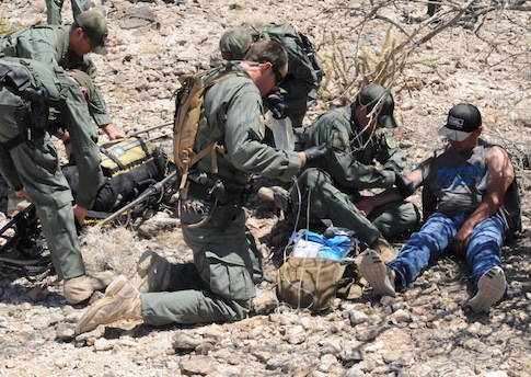 Border Patrol Rescue Team administers an I.V. to help an illegal border crosser. / AP