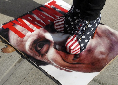 A member of NY2A Grassroots Coalition, stands on an image of New York Gov. Andrew Cuomo / AP