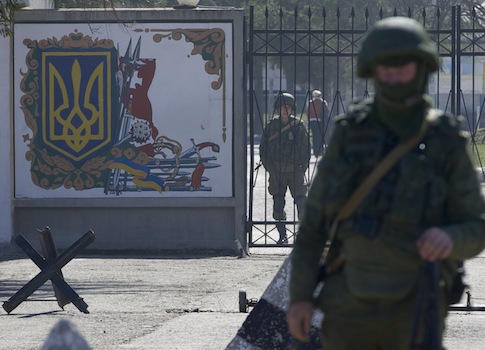 Russian soldiers guard the entrance to the Ukrainian military base in Perevalne, Crimea / AP