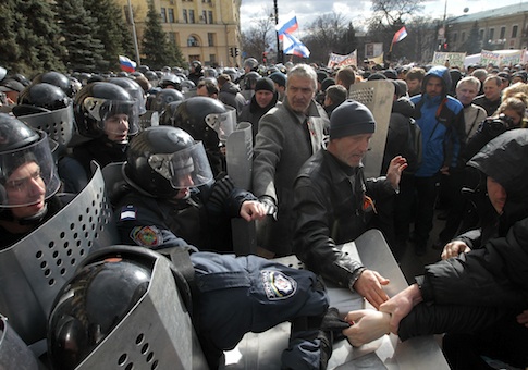 Ukrainian riot police officers tussle with pro-Russia supporters