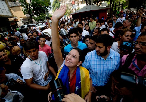 Maria Corina Machado greets supporters upon her arrival for a rally in Caracas / AP