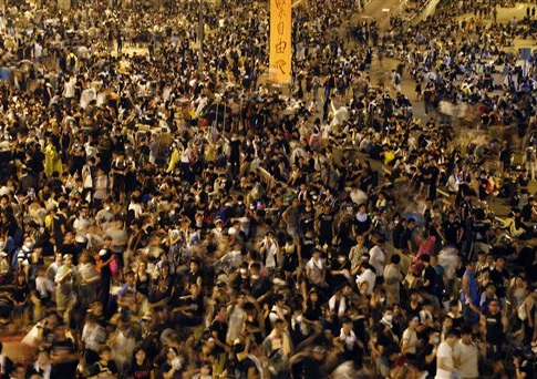 Pro-democracy protesters gather in the early hours of the morning on the streets around the government headquarters