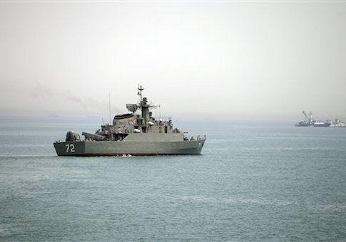 Iranian warship Alborz, foreground, prepares before leaving Iran's waters, at the Strait of Hormuz