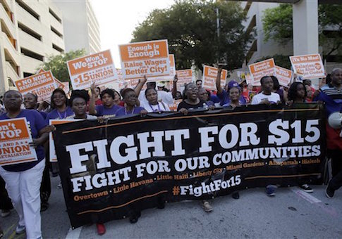Protestors march in
      support of raising the minimum wage to $15 an hour / AP