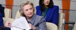 Huma Abedin sits close behind Hillary Clinton