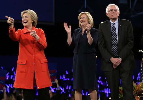 Iowa Democratic Party chair Andy McGuire stands between Hillary Clinton and Bernie Sanders / AP