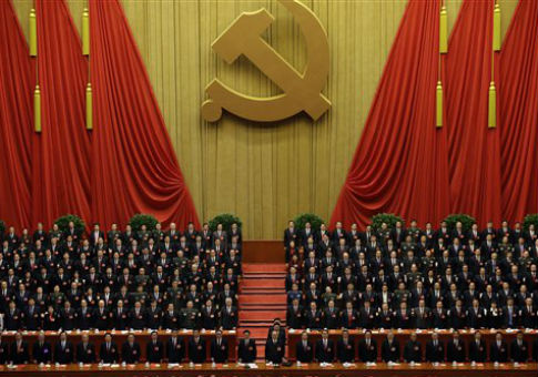 Chinese Communist Party leaders stand up while the international communist anthem is played. / AP