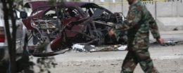 Afghan national army soldier walks by explosion site near U.S. Embassy in Kabul, Afghanistan, Aug. 15, 2016 / AP