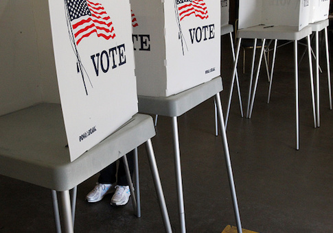 A voter casts their ballot at a polling station