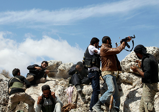 Free Syrian Army fighters fire weapons