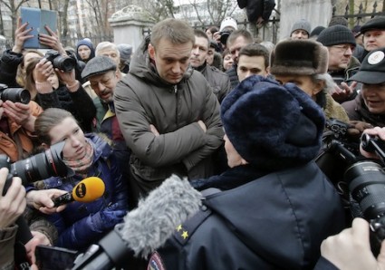 Opposition leader Navalny speaks to a police officer outside a courthouse in Moscow