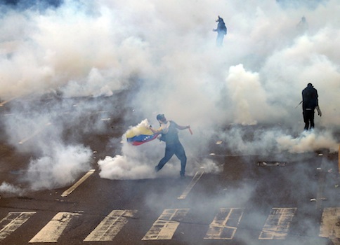 A protestor is teargassed by police in Caracas, Venezuela / AP