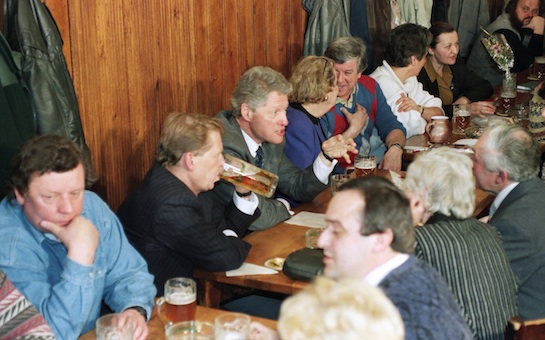 U.S. President Bill Clinton talks with guests in the Golden Tiger pub in downtown Prague