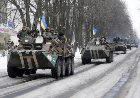 Members of the Ukrainian armed forces drive armored vehicles in the town of Volnovakha, eastern Ukraine, January 18, 2015