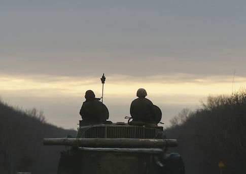 Ukrainian servicemen ride on a military vehicle near Artemivsk February 19, 2015