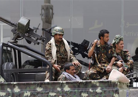Shiite rebels, known as Houthis, wearing an army uniform, ride on an armed truck to patrol the international airport in Sanaa, Yemen