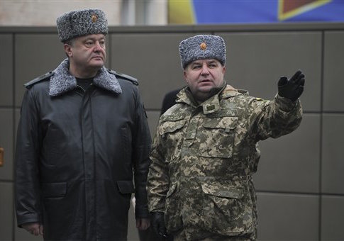 Ukraine's President Petro Poroshenko, left, and defense minister Stepan Poltorak, talk at the National Guard Training Center in Novy Petrivtsy, Ukraine, Friday, Feb. 13