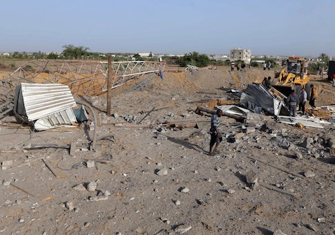 Palestinians survey a Hamas site after it was hit by an Israeli airstrike in Rafah in the southern Gaza Strip