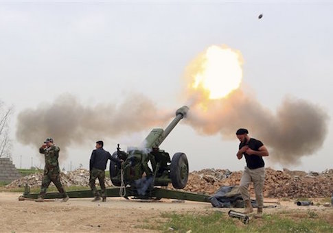 Iraqi security forces fire at ISIS militants positions from villages south of Mosul /