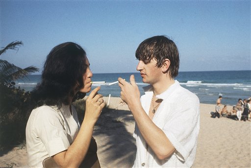 Ringo Starr of the Beatles gives an unidentified person a light at the beach in Miami, Florida in February 1964. (AP Photo)