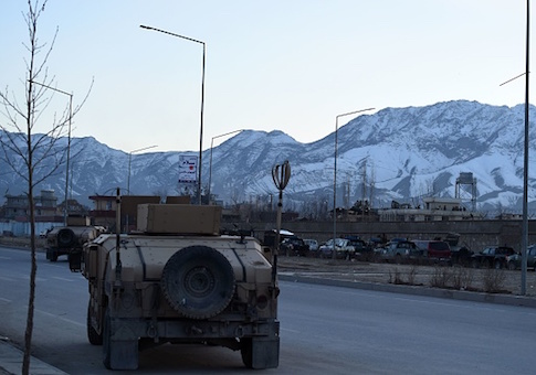 Afghan security forces arrive at the site of a suicide car bombing that targeted an Afghan police district headquarters building