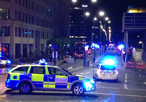 A photograph taken on a mobile phone shows British police cars blocking the entrance to London Bridge, in central London