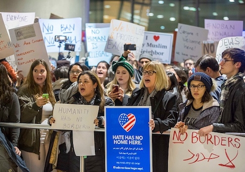 Protestors rally at a demonstration against the new ban on immigration issued by President Trump at Logan International Airport in Boston