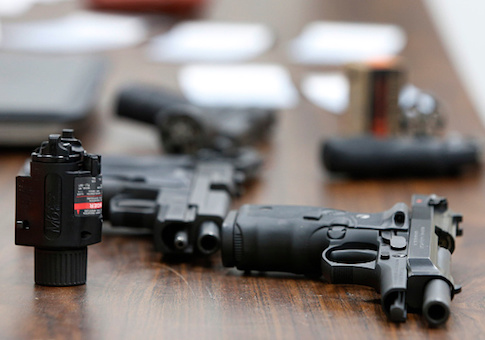 Several guns lay on a table during a class to obtain the Utah concealed gun carry permit