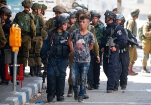 Israeli forces arrest a Palestinian youth during clashes between demonstrators and security forces in the city of Hebron