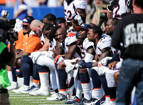 Denver Broncos players kneel during the American National Anthem before an NFL game against the Buffalo Bills on September 24, 2017 / Getty Images