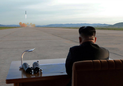 North Korean leader Kim Jong Un watches the launch of a Hwasong-12 missile