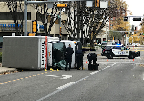 Edmonton Police investigate at the scene where a man hit pedestrians then flipped the U-Haul truck he was driving