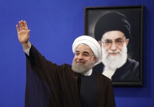 President Hassan Rouhani in front of a portrait of Iran's Supreme Leader Ayatollah Ali Khamenei