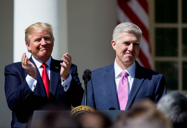 U.S. Supreme Court Justice Judge Neil Gorsuch speaks as President Donald Trump looks on