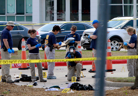 Investigators work the crime scene outside of the Curtis Culwell Center after a shooting occurred