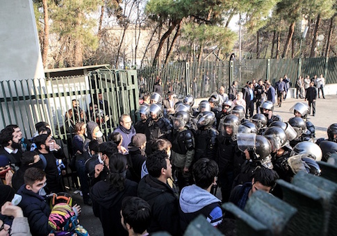 Iranian students scuffle with police at the University of Tehran during a demonstration driven by anger over economic problems