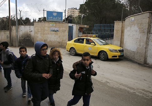 Palestinian boys walk past a United Nations' run school in the Qalandia refugee camp near Ramallah in the West Bank