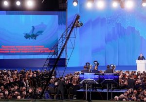 The video screen shows an unmanned nuclear-powered submersible as Russia's President Vladimir Putin delivers an annual address to the Federal Assembly of the Russian Federation