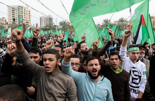 Palestinians attend a rally marking the 31st anniversary of Hamas' founding, in Gaza City
