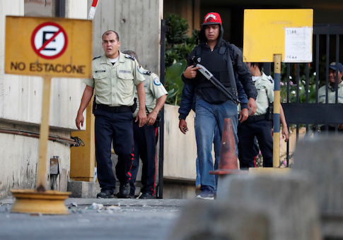 Security forces are seen after looting during an ongoing blackout in Caracas, Venezuela