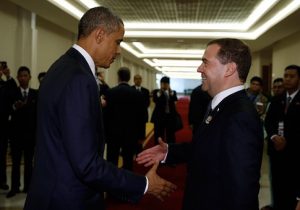 Former Russian Prime Minister Dmitry Medvedev shakes hands with President Barack Obama