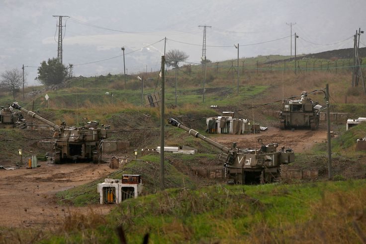 Israeli self-propelled howitzers are positioned in the Israeli-annexed Golan Heights on the border with Syria